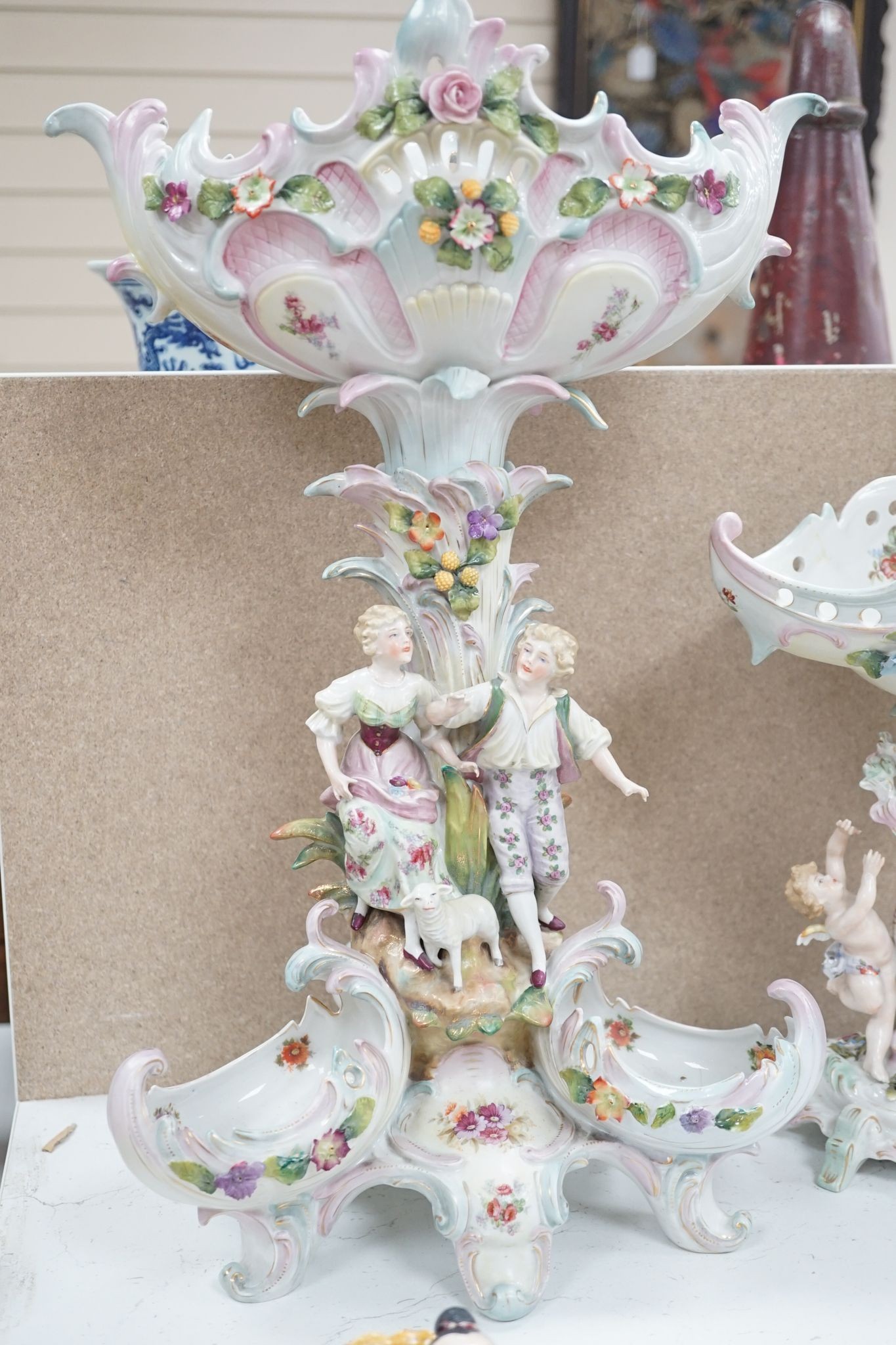A tall German porcelain figural centrepiece bowl and two others smaller. Tallest 47cm